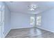 Bright bedroom with wood-look floors and ceiling fan at 5103 Ashcrest Ct, Tampa, FL 33647