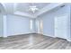 Spacious bedroom with light grey walls, ceiling fan, and wood-look flooring at 5103 Ashcrest Ct, Tampa, FL 33647