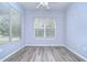 Cozy bedroom with large window and wood-look floors at 5103 Ashcrest Ct, Tampa, FL 33647