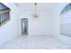 Spacious dining room with marble floors and a modern chandelier at 5103 Ashcrest Ct, Tampa, FL 33647