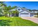 Two-story house with a large driveway and landscaped lawn at 5103 Ashcrest Ct, Tampa, FL 33647