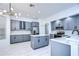 Modern kitchen featuring gray cabinets, stainless steel appliances, and white quartz countertops at 5103 Ashcrest Ct, Tampa, FL 33647