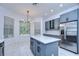 Modern kitchen with gray cabinets, stainless steel appliances and an island at 5103 Ashcrest Ct, Tampa, FL 33647