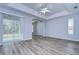 Living room featuring wood-look flooring and a sliding glass door at 5103 Ashcrest Ct, Tampa, FL 33647