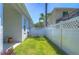 Side yard with white fence, gate, and grassy area at 5103 Ashcrest Ct, Tampa, FL 33647