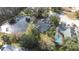 Aerial view of the house and surrounding neighborhood, near a pond at 5200 Lagos Ct, New Port Richey, FL 34655