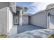 Front entry with light gray stucco and arched entryway at 5200 Lagos Ct, New Port Richey, FL 34655