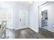 Interior view showing a hallway with gray floors and a door to a bathroom at 5200 Lagos Ct, New Port Richey, FL 34655