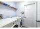 Laundry room with washer, dryer, and shelving at 5200 Lagos Ct, New Port Richey, FL 34655