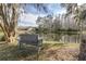 Serene pond-side view with a bench, perfect for relaxation at 5200 Lagos Ct, New Port Richey, FL 34655