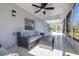 Relaxing screened porch with patio furniture, ceiling fan, and tiled floor at 5200 Lagos Ct, New Port Richey, FL 34655