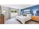 Spacious bedroom with a large bed and blue accent wall at 5314 Oxford Gray Rd, Wesley Chapel, FL 33545