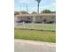 Tan single-story house with white picket fence and small front yard at 6502 W Clifton St, Tampa, FL 33634