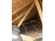 Image shows the attic space with exposed insulation and wooden beams at 6549 Brentwood Dr, Zephyrhills, FL 33542