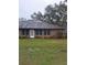 Brick building with a grassy yard at 6549 Brentwood Dr, Zephyrhills, FL 33542