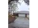 Brick home with a two-car garage and landscaping at 6549 Brentwood Dr, Zephyrhills, FL 33542