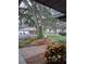 Brick walkway leads to the house, with a large oak tree in the background at 6549 Brentwood Dr, Zephyrhills, FL 33542