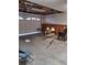 Unfinished garage interior with open overhead door and some debris at 6549 Brentwood Dr, Zephyrhills, FL 33542