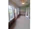 Sunroom with tiled floors and windows, currently under renovation at 6549 Brentwood Dr, Zephyrhills, FL 33542