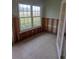 Sunroom with large window and tiled floor, showing damage and needs work at 6549 Brentwood Dr, Zephyrhills, FL 33542