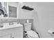 Updated bathroom with white vanity, stone tile, and modern toilet at 6706 S Kissimmee St, Tampa, FL 33616