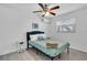 Bright bedroom with a queen bed, ceiling fan, and window blinds at 6706 S Kissimmee St, Tampa, FL 33616