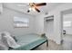 Cozy bedroom with a queen bed, ceiling fan, and built-in closet at 6706 S Kissimmee St, Tampa, FL 33616