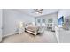 Bright bedroom with a queen bed, ceiling fan, and plenty of natural light at 7532 Ashbrooke Pine Loop, Odessa, FL 33556