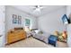 Cozy bedroom with striped bedding, dresser, and fun decor at 7532 Ashbrooke Pine Loop, Odessa, FL 33556