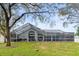 Screened enclosure in a large backyard at 8535 Delaware Dr, Weeki Wachee, FL 34607