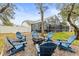 Backyard with fire pit, seating, and screened enclosure at 8535 Delaware Dr, Weeki Wachee, FL 34607