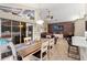 Dining area with farmhouse table, pool view, and kitchen access at 8535 Delaware Dr, Weeki Wachee, FL 34607