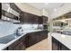 Modern kitchen with dark cabinetry, quartz countertops and stainless steel appliances at 8535 Delaware Dr, Weeki Wachee, FL 34607