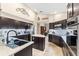 Modern kitchen with dark cabinetry, quartz counters, and stainless steel appliances at 8535 Delaware Dr, Weeki Wachee, FL 34607