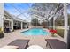 Large, screened pool and patio with lounge chairs at 8535 Delaware Dr, Weeki Wachee, FL 34607