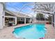 Large, screened pool and patio with lounge chairs at 8535 Delaware Dr, Weeki Wachee, FL 34607