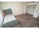 Bright bedroom with grey carpet and large closet at 8615 Greenfield Ln, Zephyrhills, FL 33541