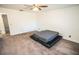 Large bedroom with grey carpet and a queen-sized bed at 8615 Greenfield Ln, Zephyrhills, FL 33541