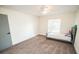 Well-lit bedroom with grey carpet and a twin-sized bed at 8615 Greenfield Ln, Zephyrhills, FL 33541