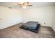 Spacious bedroom with plush carpet and ceiling fan at 8615 Greenfield Ln, Zephyrhills, FL 33541