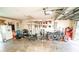 Garage with gym equipment and motorcycle storage at 8615 Greenfield Ln, Zephyrhills, FL 33541