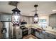 Modern kitchen with pendant lighting and stainless steel appliances at 8615 Greenfield Ln, Zephyrhills, FL 33541