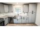 Modern kitchen with farmhouse sink and stainless steel appliances at 8615 Greenfield Ln, Zephyrhills, FL 33541