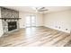 Spacious living room featuring a stone fireplace and vinyl plank flooring at 8615 Greenfield Ln, Zephyrhills, FL 33541