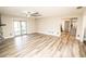 Bright living area with wood-look floors and access to the kitchen at 8615 Greenfield Ln, Zephyrhills, FL 33541