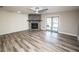 Living room with a stone fireplace and wood-look flooring at 8615 Greenfield Ln, Zephyrhills, FL 33541