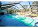 Spacious screened pool with a slide and backyard view at 8615 Greenfield Ln, Zephyrhills, FL 33541