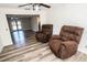 Cozy sitting area with two recliners and wood-style flooring at 8615 Greenfield Ln, Zephyrhills, FL 33541