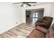 Comfortable sitting area with two brown recliners and wood-look floors at 8615 Greenfield Ln, Zephyrhills, FL 33541