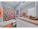 Bathroom with tub, peach vanity and patterned shower curtain at 8967 Indigo Trail Loop, Riverview, FL 33578